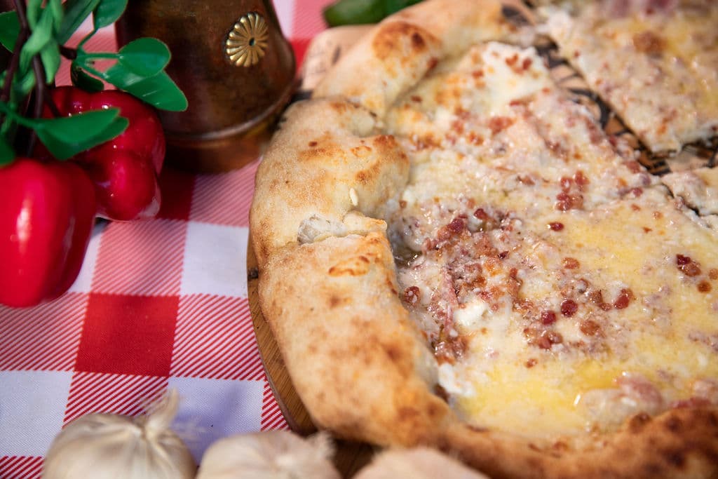 A slice of wood-fired pizza ready to serve